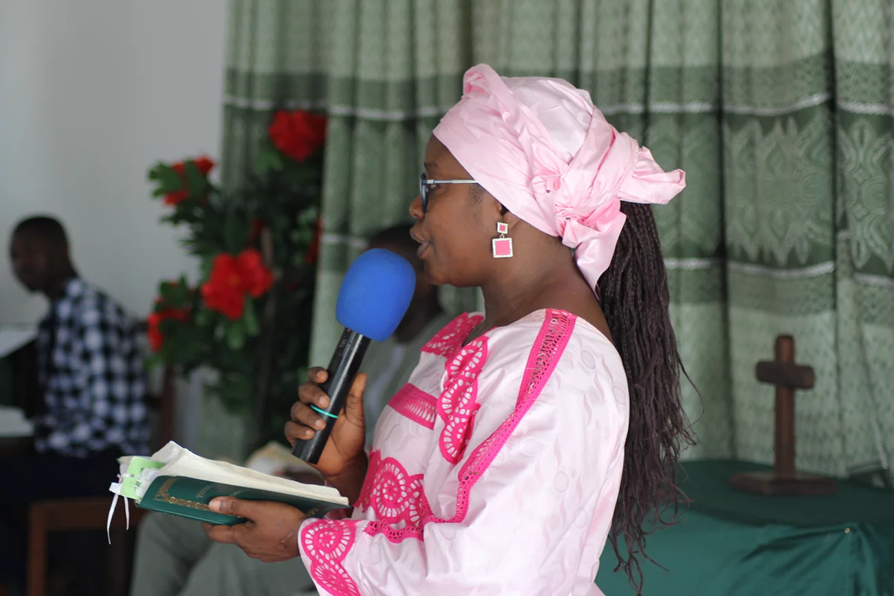 Paulette translates into Wolof in church.jpg